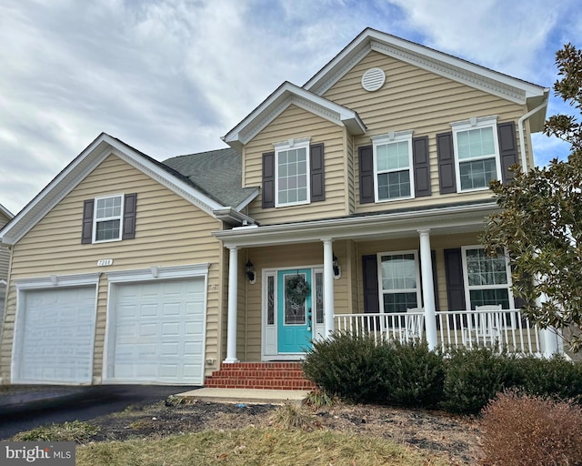 view of front of house featuring a garage and a porch