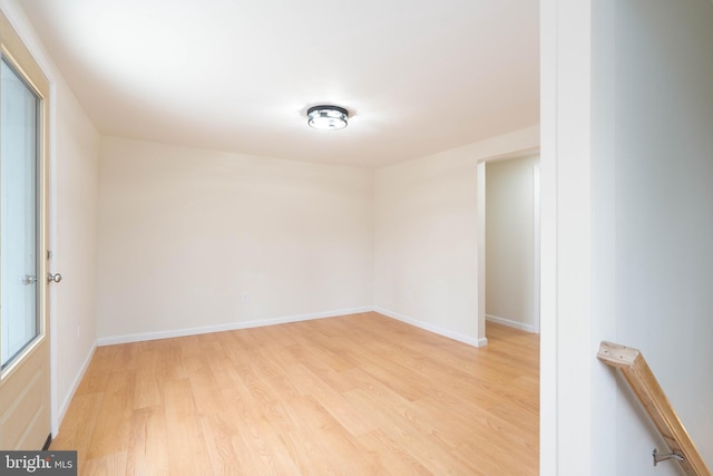 empty room with light hardwood / wood-style flooring