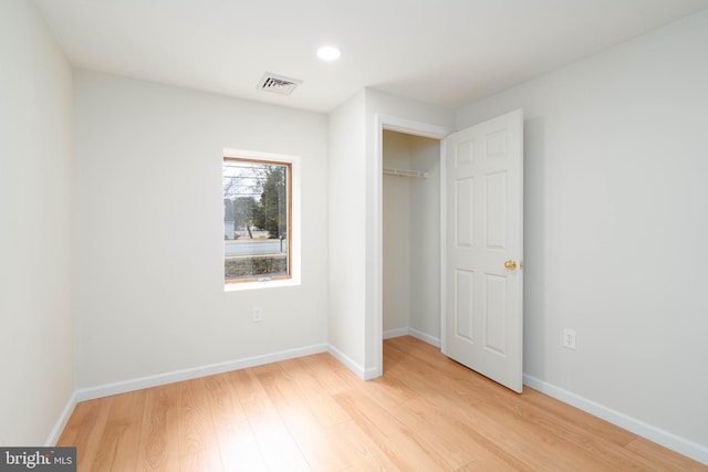 unfurnished bedroom featuring a closet and light hardwood / wood-style flooring