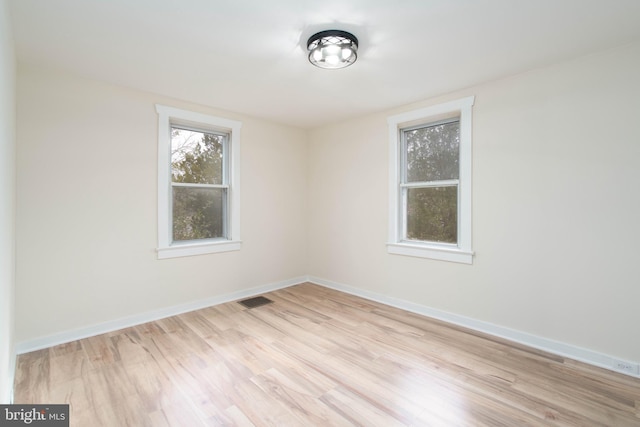 spare room with light hardwood / wood-style floors