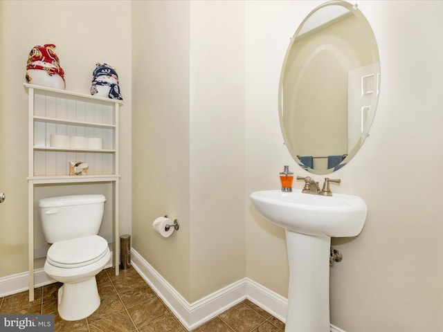 bathroom featuring sink, toilet, and tile patterned floors