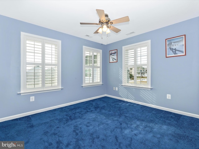 unfurnished room featuring ceiling fan and dark colored carpet