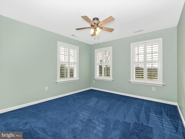 carpeted spare room featuring ceiling fan