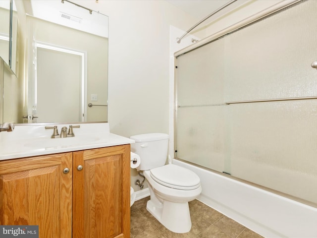 full bathroom featuring enclosed tub / shower combo, vanity, and toilet