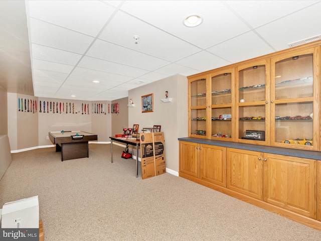 recreation room with a drop ceiling and carpet floors