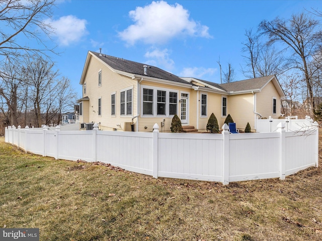 rear view of property featuring a yard