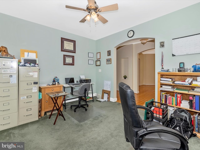 carpeted home office with ceiling fan