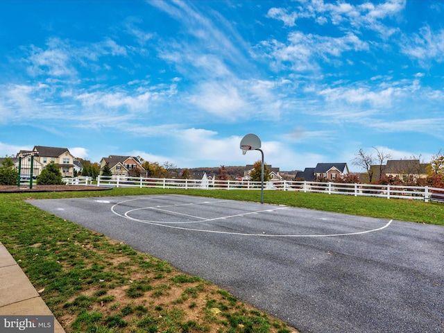 view of sport court with a yard