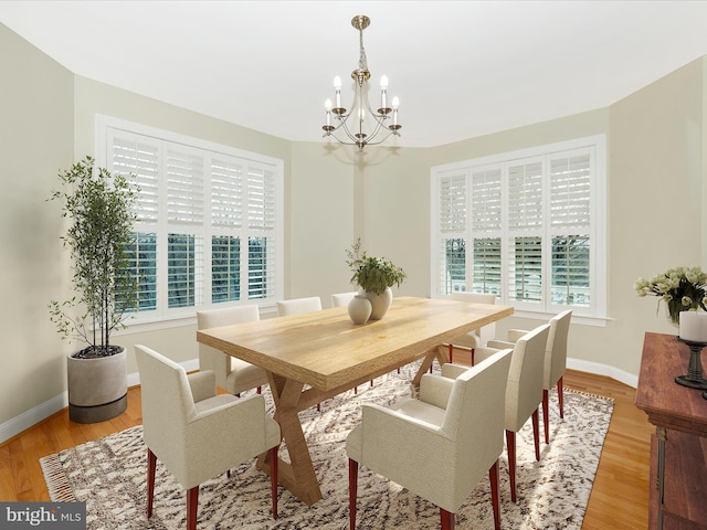 dining room with a notable chandelier and light hardwood / wood-style floors