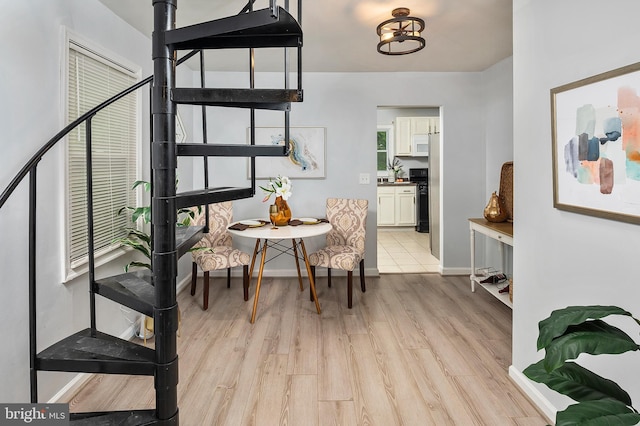 dining room featuring light wood-style floors and baseboards