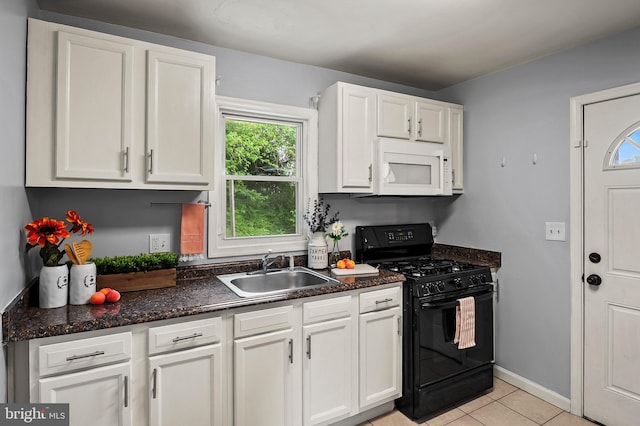 kitchen with white microwave, black range with gas cooktop, a sink, and white cabinets