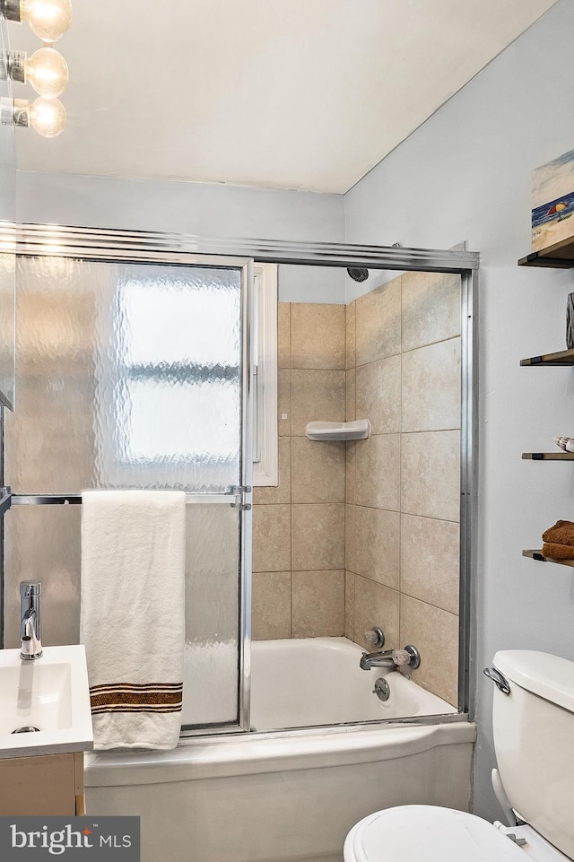 full bathroom with toilet, enclosed tub / shower combo, and vanity