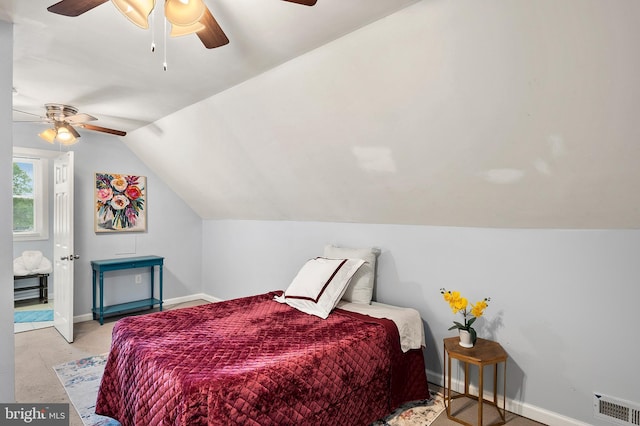 bedroom featuring lofted ceiling, baseboards, and a ceiling fan