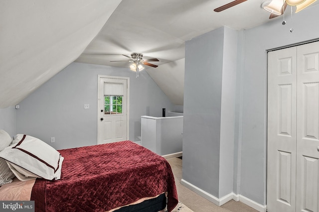 bedroom featuring carpet floors, lofted ceiling, baseboards, ceiling fan, and a closet