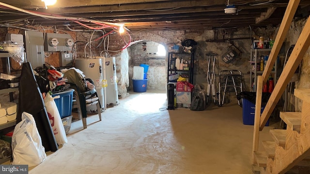 basement featuring electric panel and water heater