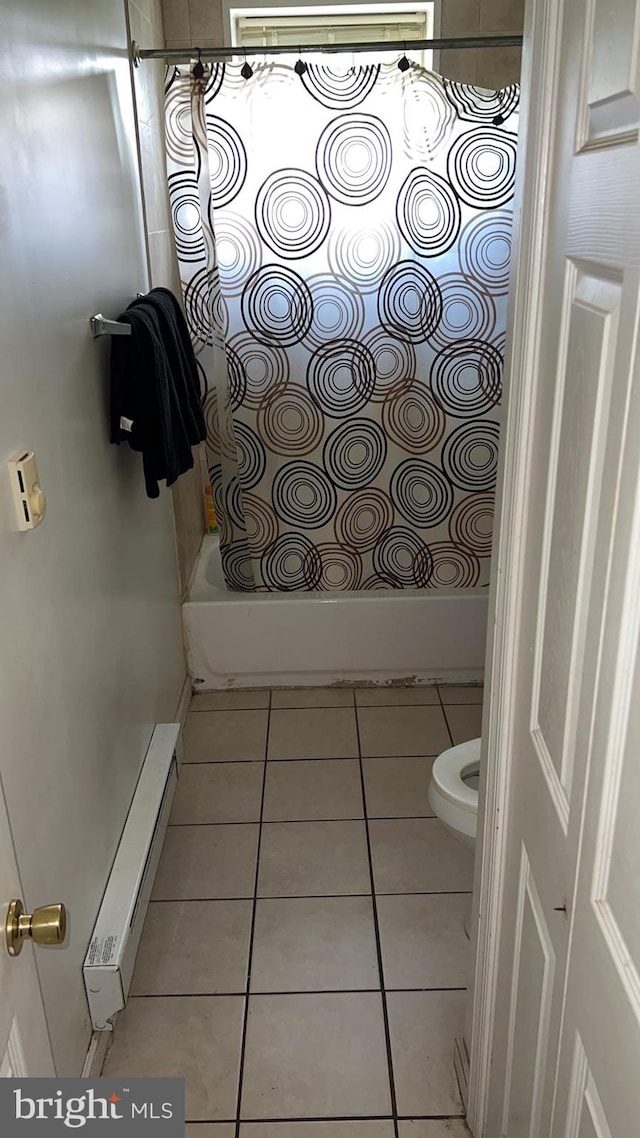 bathroom featuring toilet, tile patterned flooring, and a baseboard heating unit