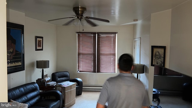 carpeted home office featuring baseboard heating and ceiling fan