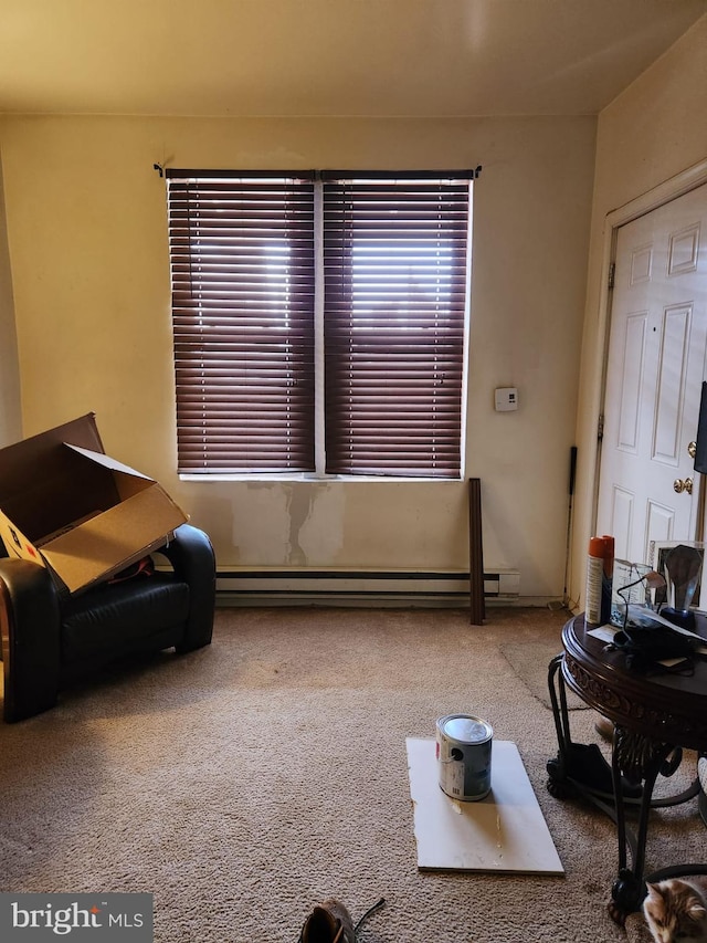 living room with carpet and a baseboard heating unit