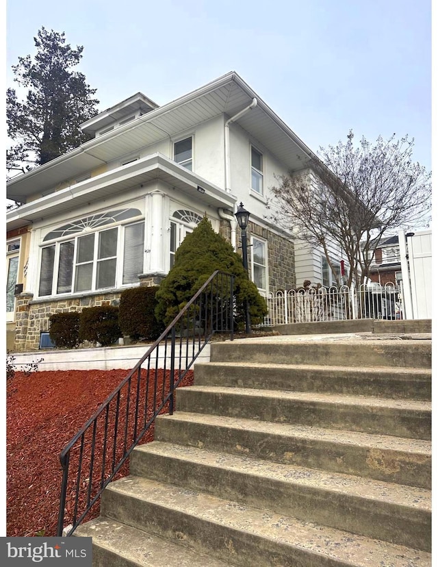 view of side of home with stone siding