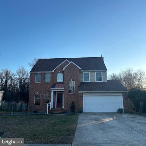 view of front facade featuring a front yard, brick siding, driveway, and an attached garage