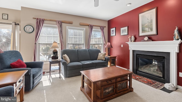 living room with a fireplace with flush hearth, a wealth of natural light, and light colored carpet