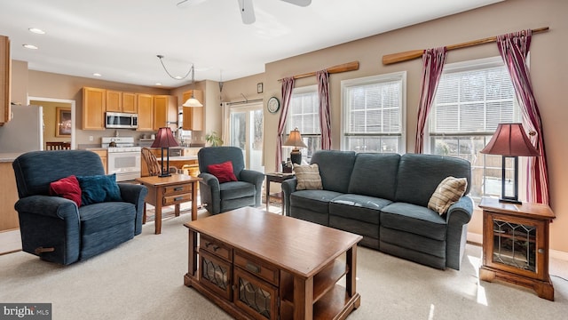 living area with light colored carpet, a ceiling fan, and recessed lighting