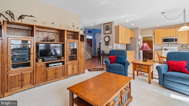 living room with recessed lighting, light colored carpet, and stairway