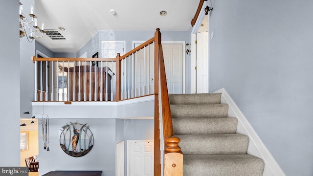 stairway featuring visible vents