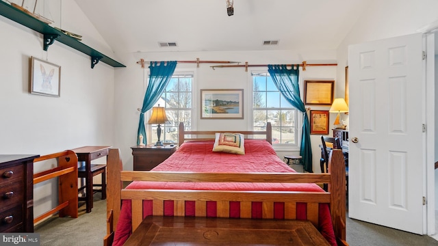 bedroom with visible vents, vaulted ceiling, and carpet flooring