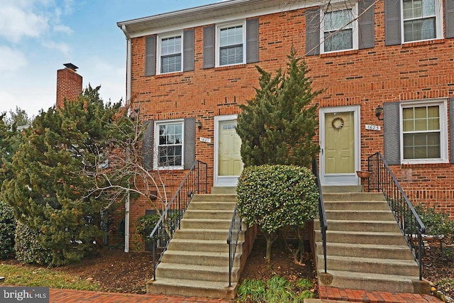 view of front of home featuring entry steps and brick siding