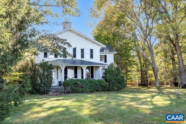 view of front of home featuring a front yard and a porch