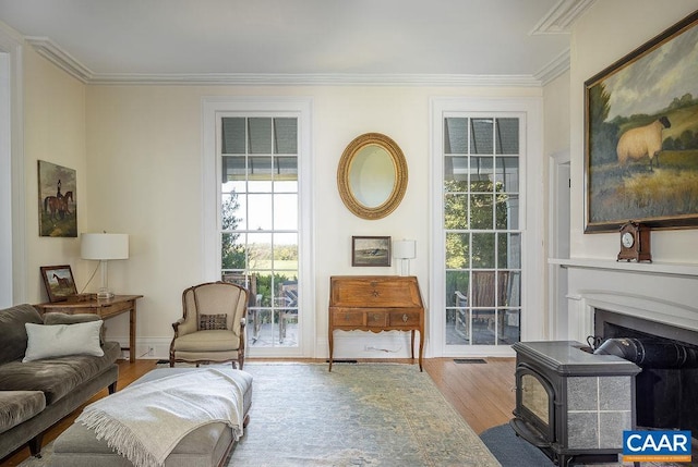 sitting room with crown molding and hardwood / wood-style flooring