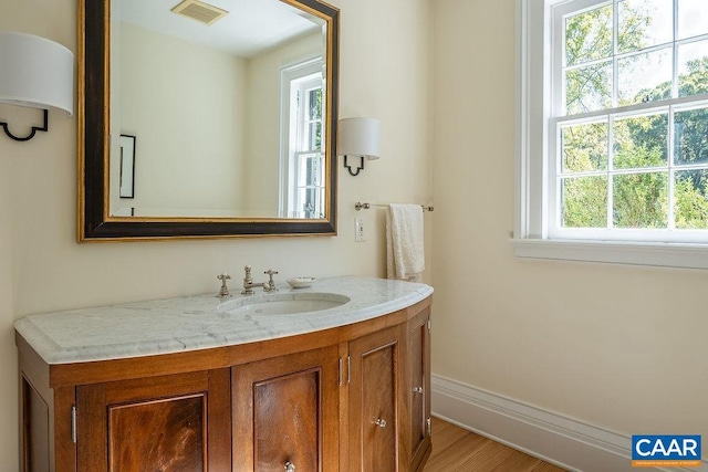 bathroom with hardwood / wood-style flooring and vanity