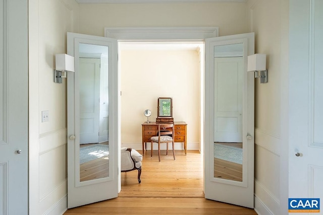 doorway with french doors and light hardwood / wood-style flooring