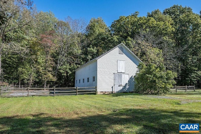 view of outbuilding with a lawn