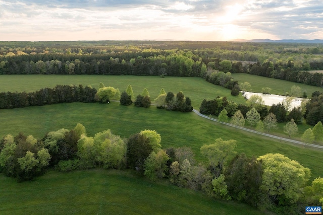 aerial view at dusk featuring a rural view