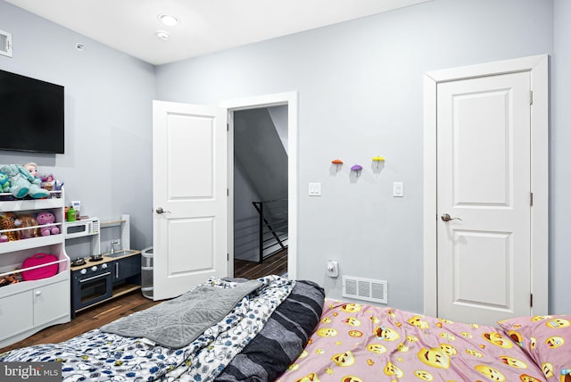 bedroom featuring dark hardwood / wood-style floors