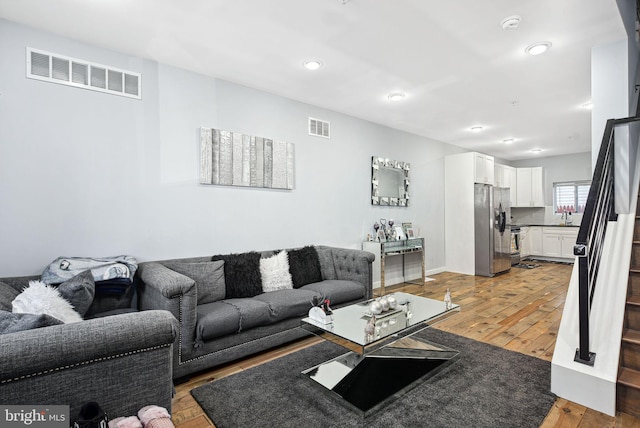 living room with sink and hardwood / wood-style floors