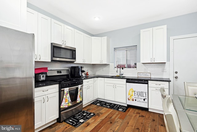 kitchen featuring sink, dark hardwood / wood-style floors, white cabinets, and appliances with stainless steel finishes