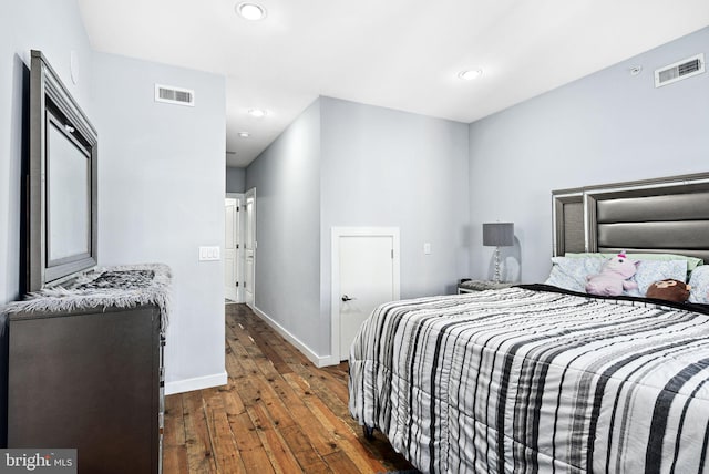 bedroom with dark hardwood / wood-style floors