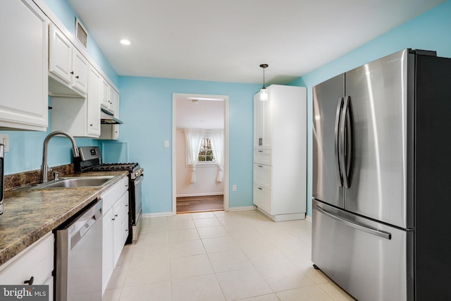 kitchen featuring light tile patterned flooring, sink, white cabinetry, hanging light fixtures, and appliances with stainless steel finishes