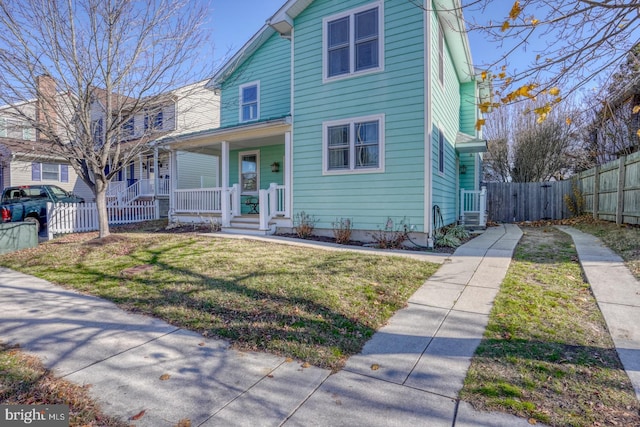 view of front of property with covered porch and a front lawn