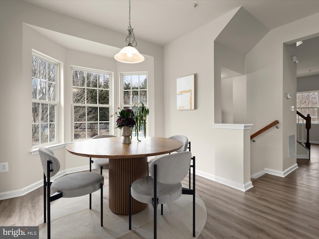 dining area with visible vents, baseboards, and wood finished floors