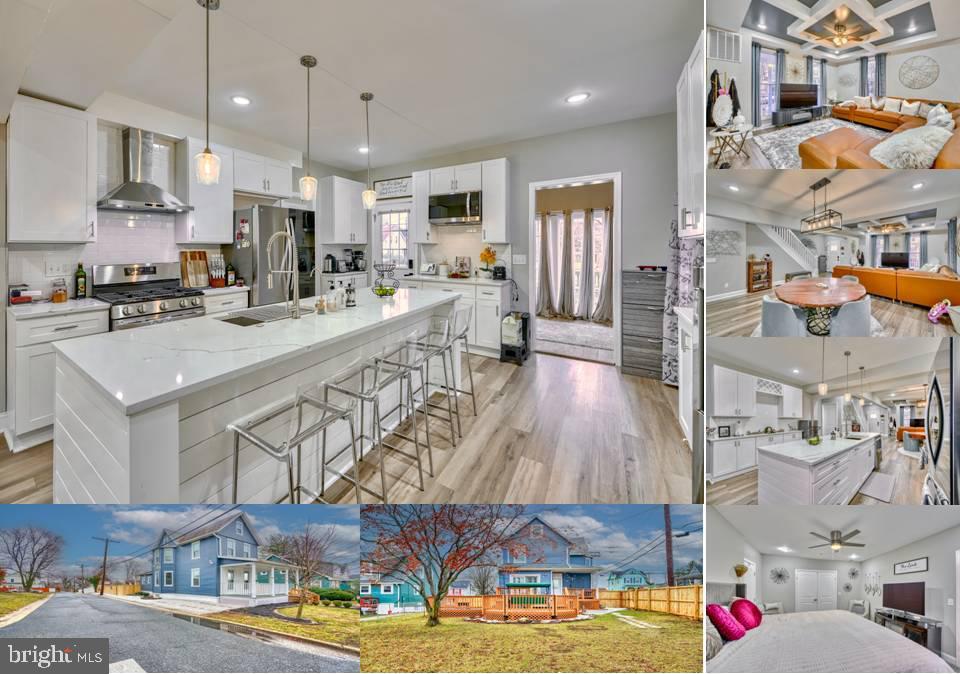 kitchen featuring stainless steel appliances, a breakfast bar area, wall chimney range hood, and white cabinets