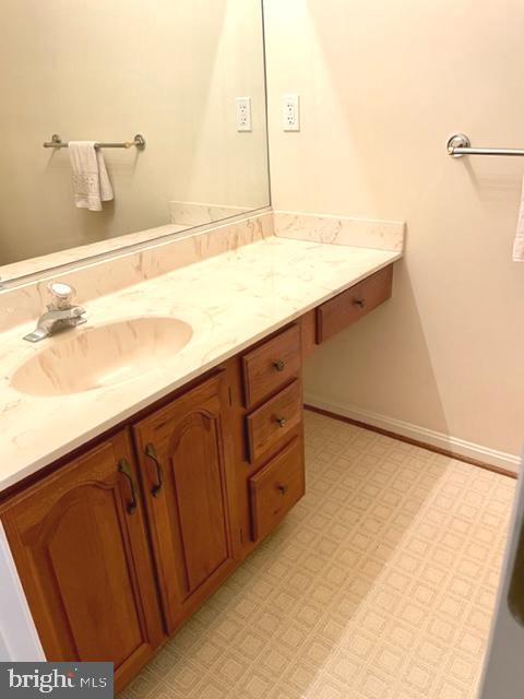 bathroom featuring vanity and baseboards