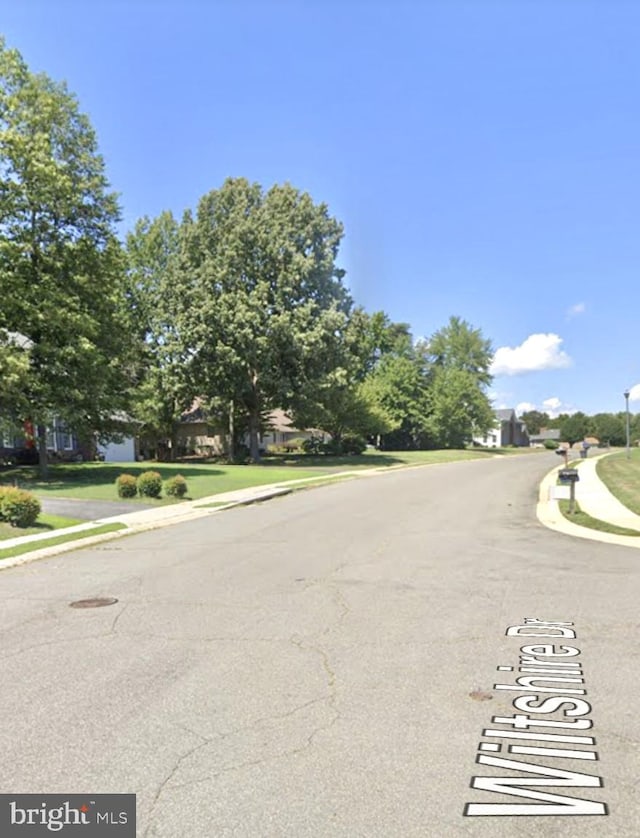 view of road featuring curbs and sidewalks