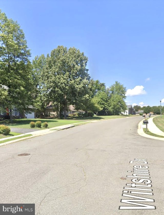 view of street with sidewalks and curbs