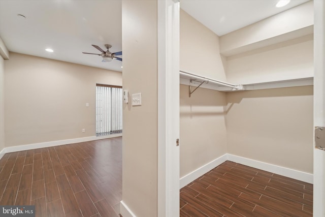 walk in closet with ceiling fan