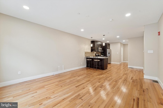 unfurnished living room featuring light hardwood / wood-style floors