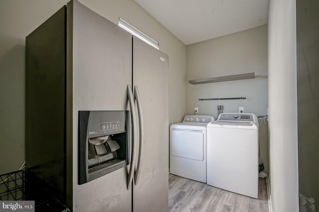 laundry area with washer and dryer, laundry area, and light wood-style flooring